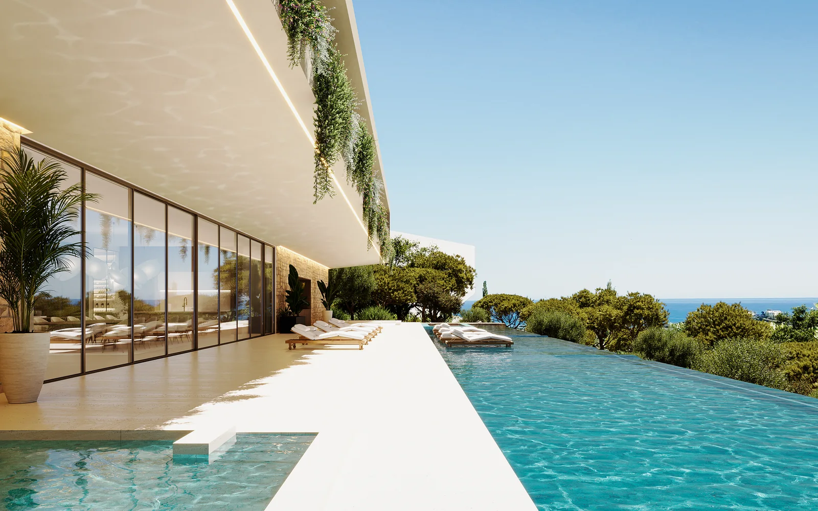 Uma piscina infinita a correr toda a extensão da casa em direcção ao mar, a água a encontrar o horizonte, com espreguiçadeiras no deck de pedra e um bordo superior plantado por cima do envidraçado.