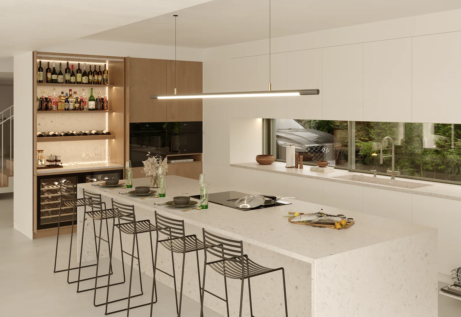A cozinha: uma única ilha em pedra clara com seis bancos e placa integrada, um candeeiro linear a todo o comprimento, garrafeira iluminada à esquerda e uma janela sobre o lava-loiça para a plantação.