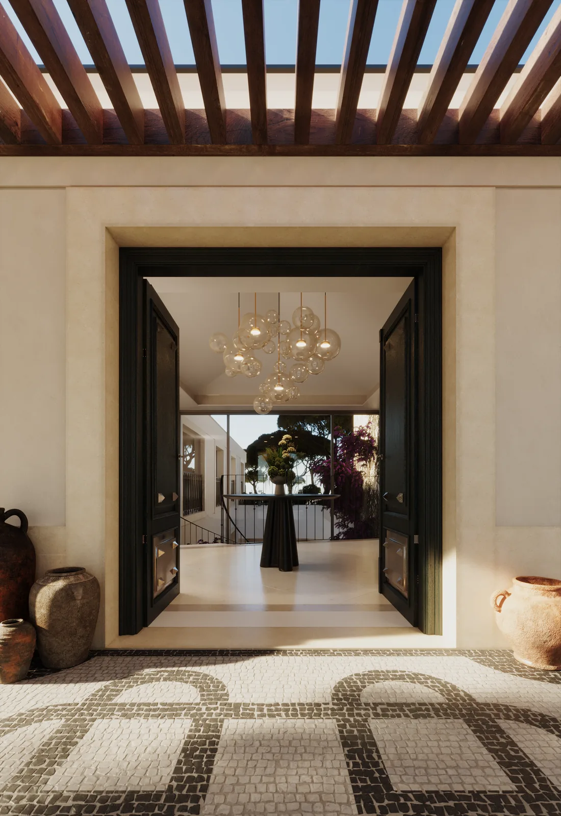 O vestíbulo: porta dupla de caixilho preto aberta sob uma pérgula de madeira, pavimento em calçada de seixo com desenho em laçaria, potes de barro dos dois lados e um lustre ao fundo.