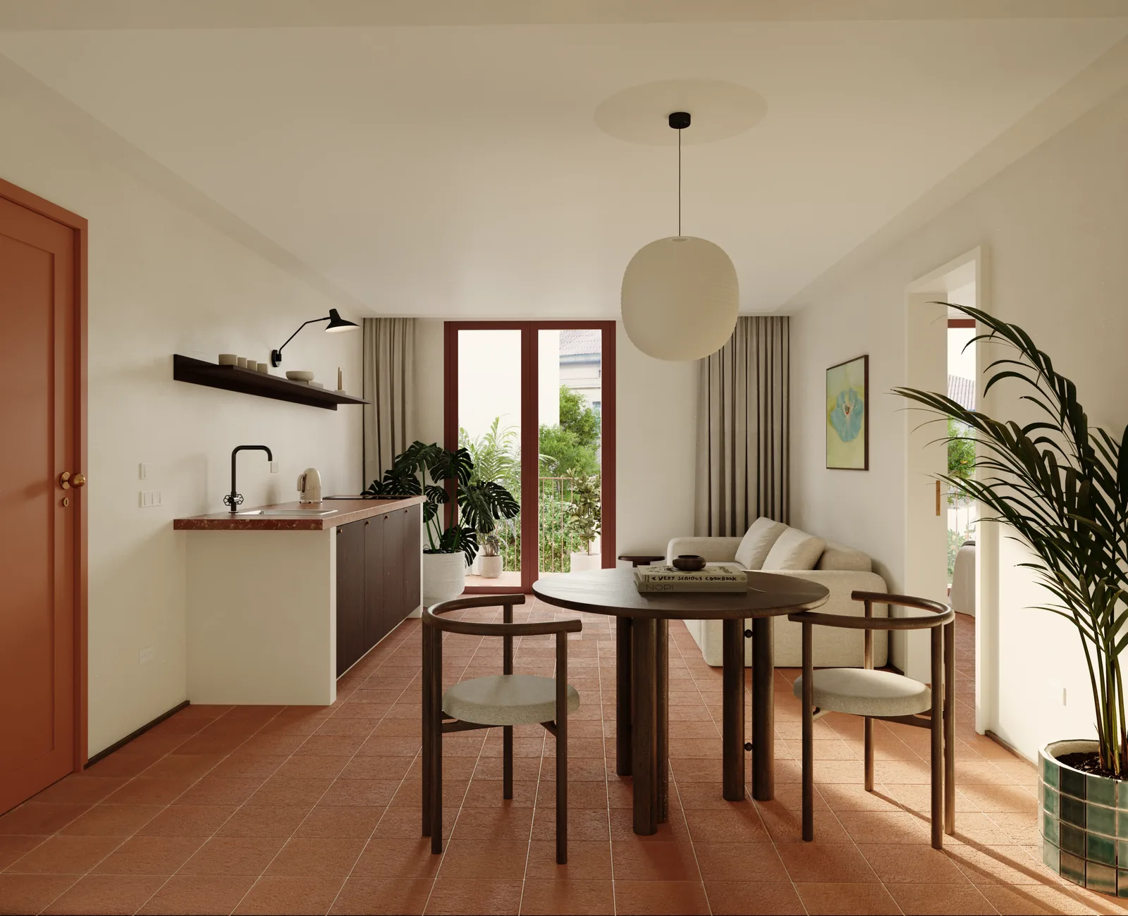 Um T1: bancada de cozinha em madeira escura à esquerda, mesa de refeições redonda com quatro cadeiras, um candeeiro de papel, e porta envidraçada para o pátio atrás de uma planta grande.